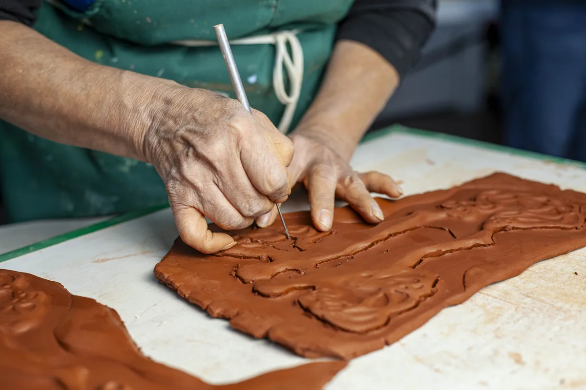 Welcome Project artisan working on tile